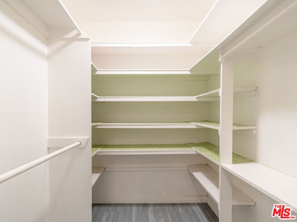 15511 Sherman Way, Unit 17 Van Nuys, CA 91406 - Photo 18 of 47 a view of walk in closet with empty racks