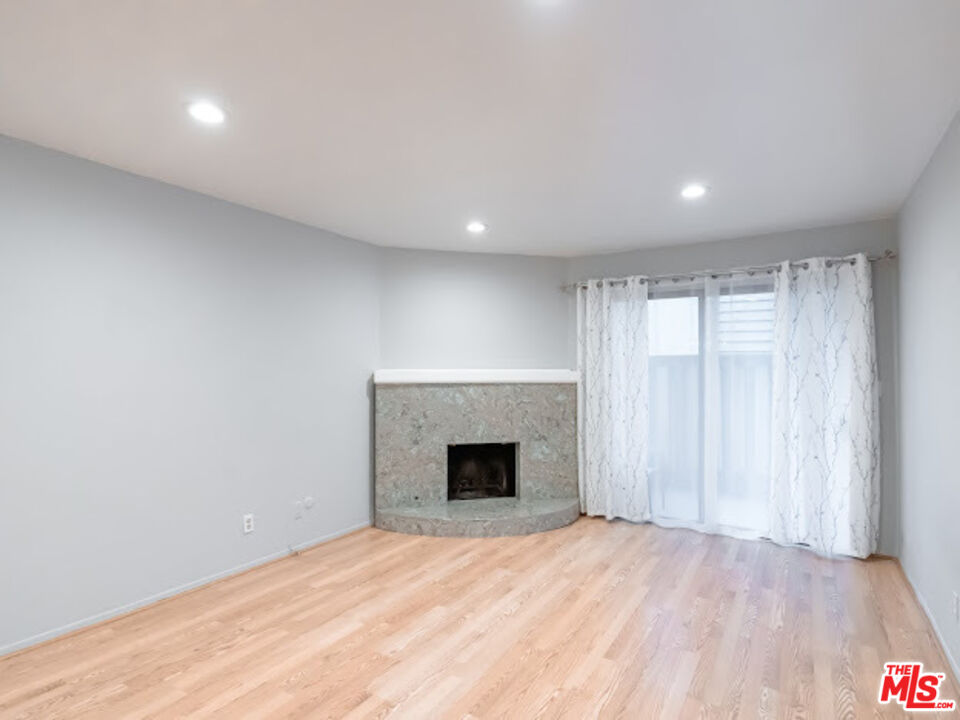 15511 Sherman Way, Unit 17 Van Nuys, CA 91406 - Photo 2 of 47 wooden floor in an empty room with a fireplace