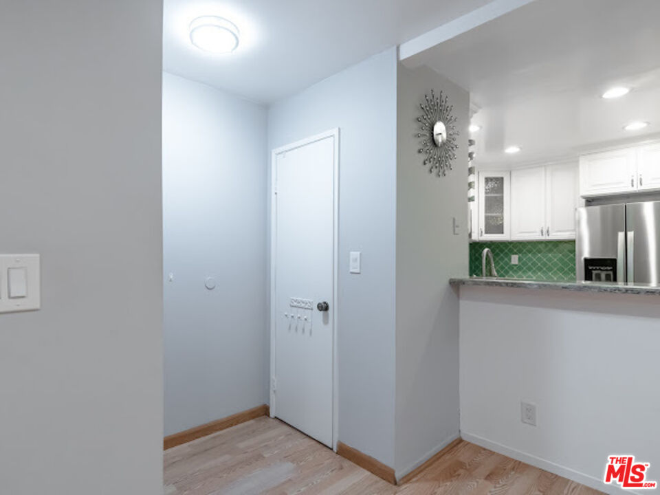 15511 Sherman Way, Unit 17 Van Nuys, CA 91406 - Photo 22 of 47 a view of a hallway with wooden floor and a bathroom