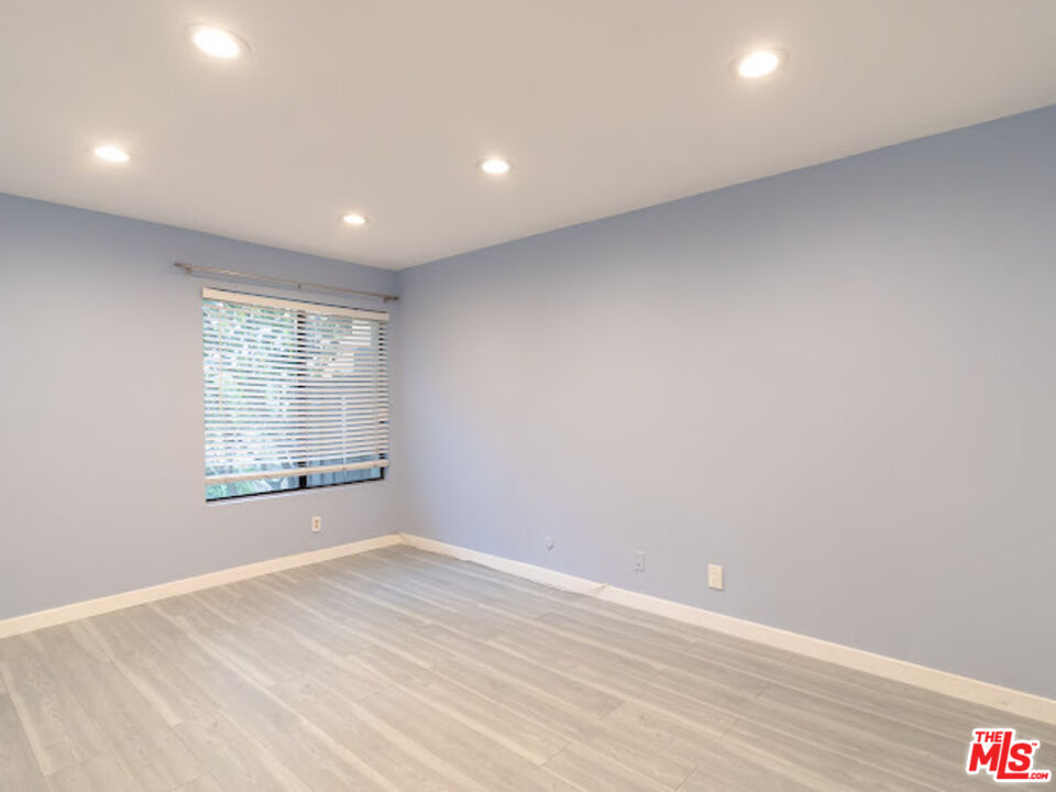 15511 Sherman Way, Unit 17 Van Nuys, CA 91406 - Photo 31 of 47 a view of empty room with wooden floor and fan