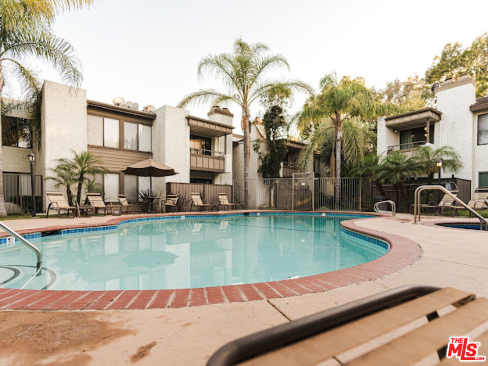 15511 Sherman Way, Unit 17 Van Nuys, CA 91406 - Photo 35 of 47 a view of a swimming pool with a lounge chair