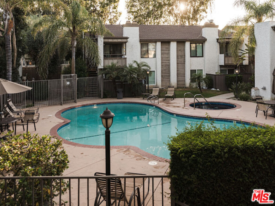 15511 Sherman Way, Unit 17 Van Nuys, CA 91406 - Photo 36 of 47 a view of a house with backyard sitting area and swimming pool