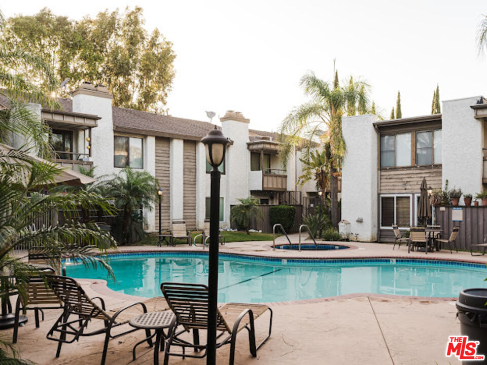 15511 Sherman Way, Unit 17 Van Nuys, CA 91406 - Photo 37 of 47 a view of a patio with table and chairs potted plants and large tree
