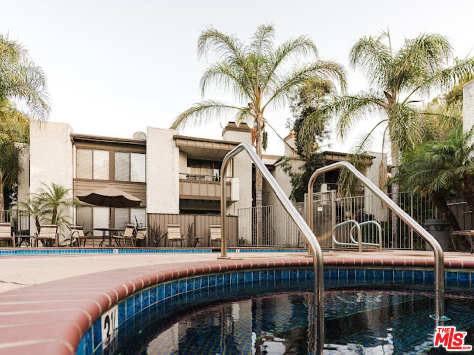 15511 Sherman Way, Unit 17 Van Nuys, CA 91406 - Photo 38 of 47 a front view of a house with swimming pool and sitting area