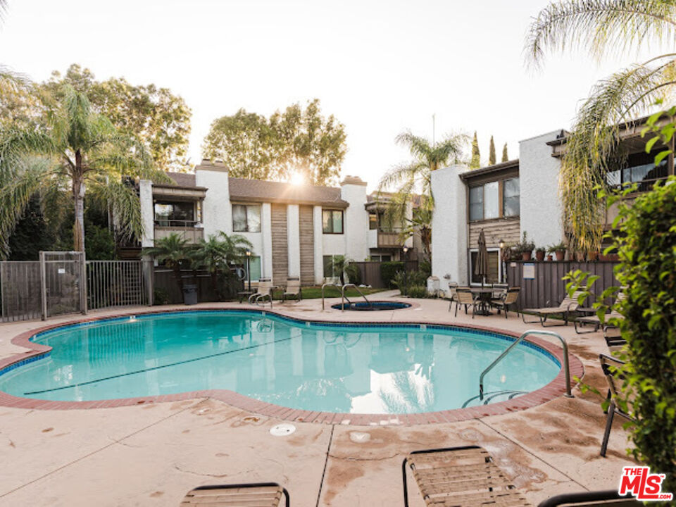 15511 Sherman Way, Unit 17 Van Nuys, CA 91406 - Photo 40 of 47 a view of a swimming pool with a lounge chairs