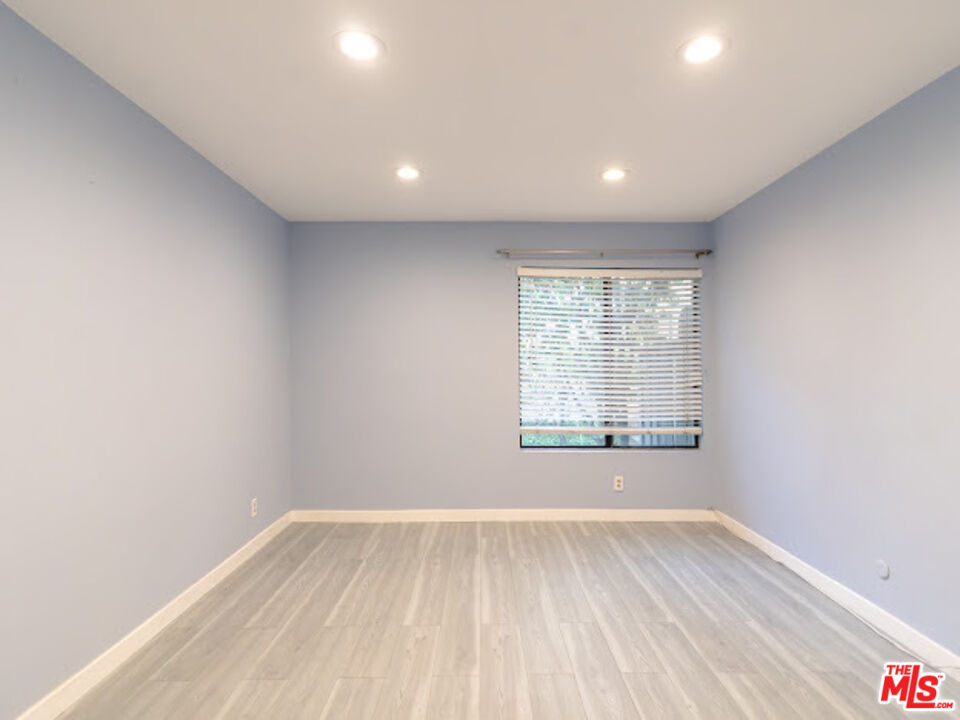 15511 Sherman Way, Unit 17 Van Nuys, CA 91406 - Photo 4 of 47 an empty room with wooden floor and windows