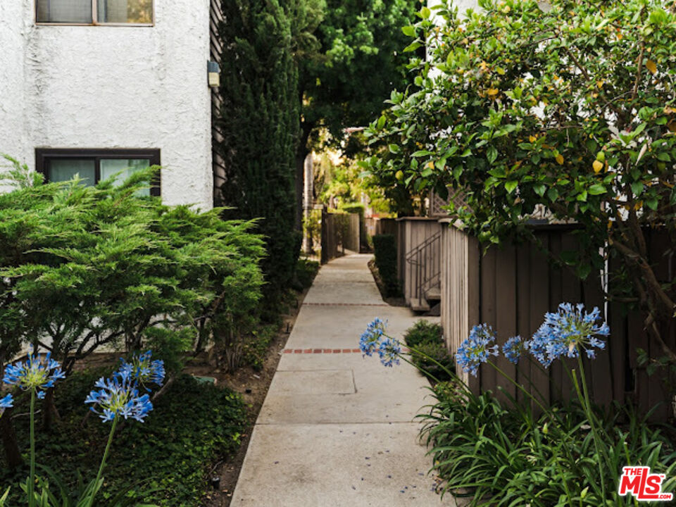 15511 Sherman Way, Unit 17 Van Nuys, CA 91406 - Photo 41 of 47 a view of a pathway covered with flower plants