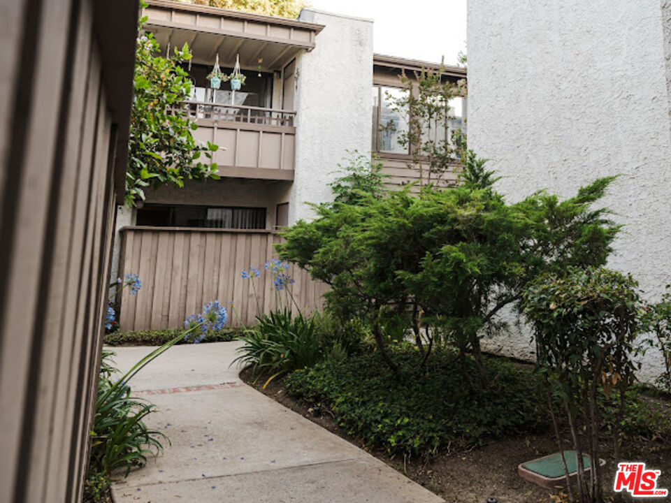 15511 Sherman Way, Unit 17 Van Nuys, CA 91406 - Photo 42 of 47 a front view of a house with a yard