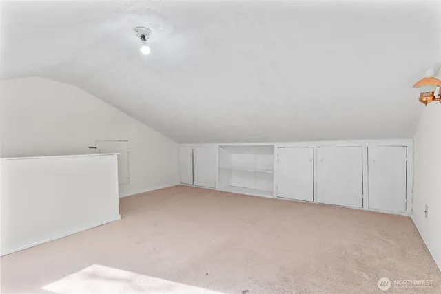 a view of a house with wooden stairs and a small yard