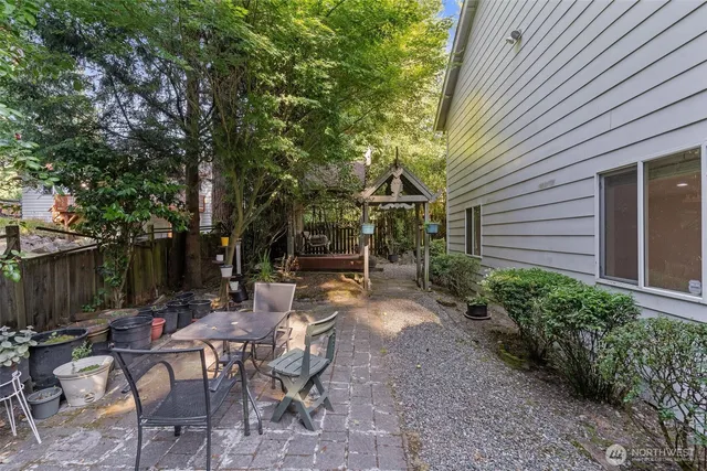 a view of a backyard with potted plants and a large tree