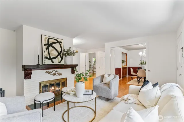 a living room with furniture a fireplace and wall painting