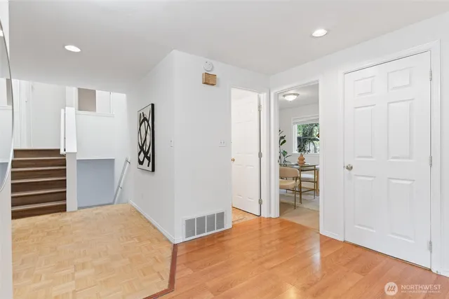 a dining room with furniture and a potted plant