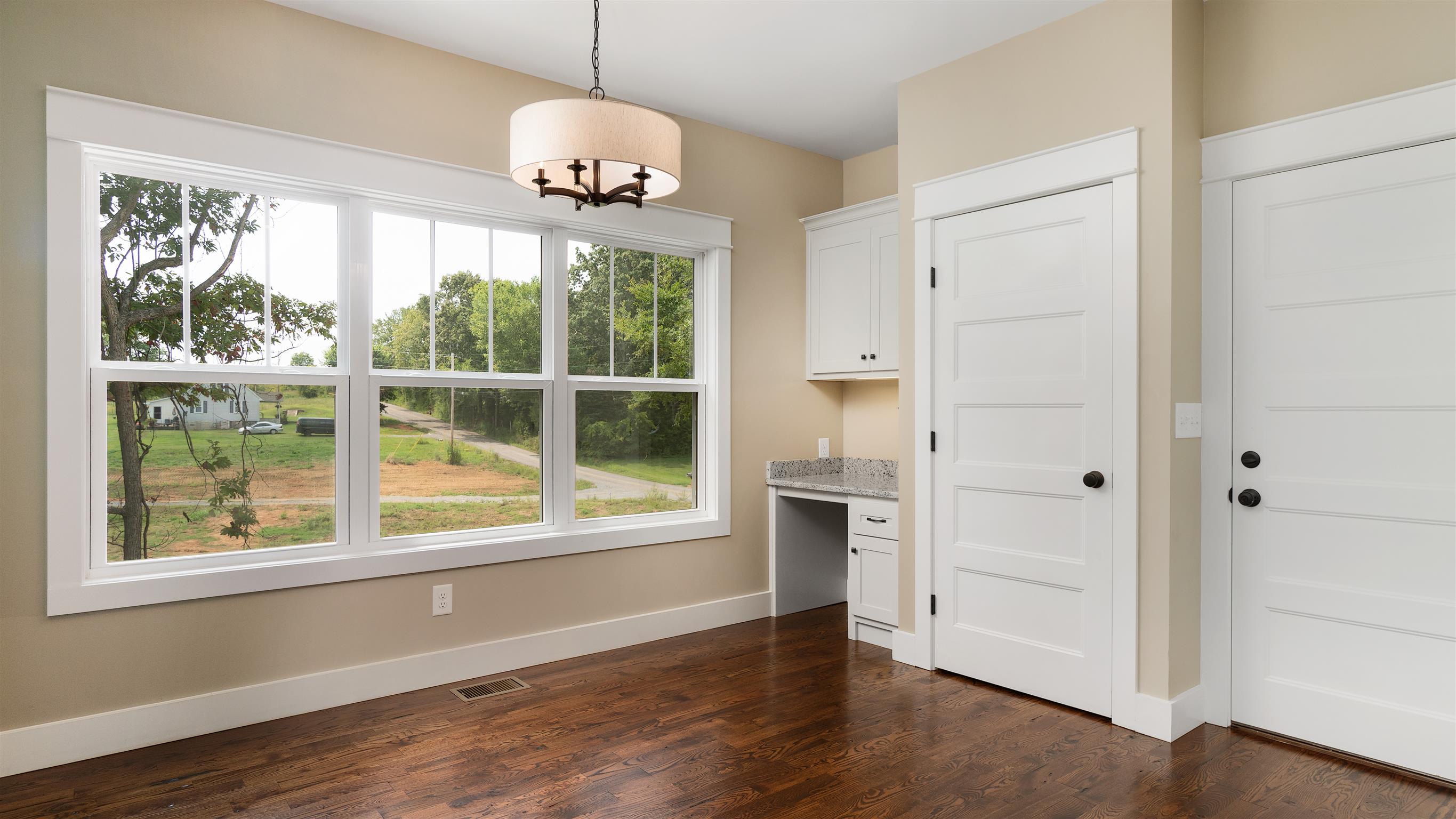 485 Tom Link Road Cottontown, TN 37048 - Photo 4 of 30 an empty room with wooden floor and windows