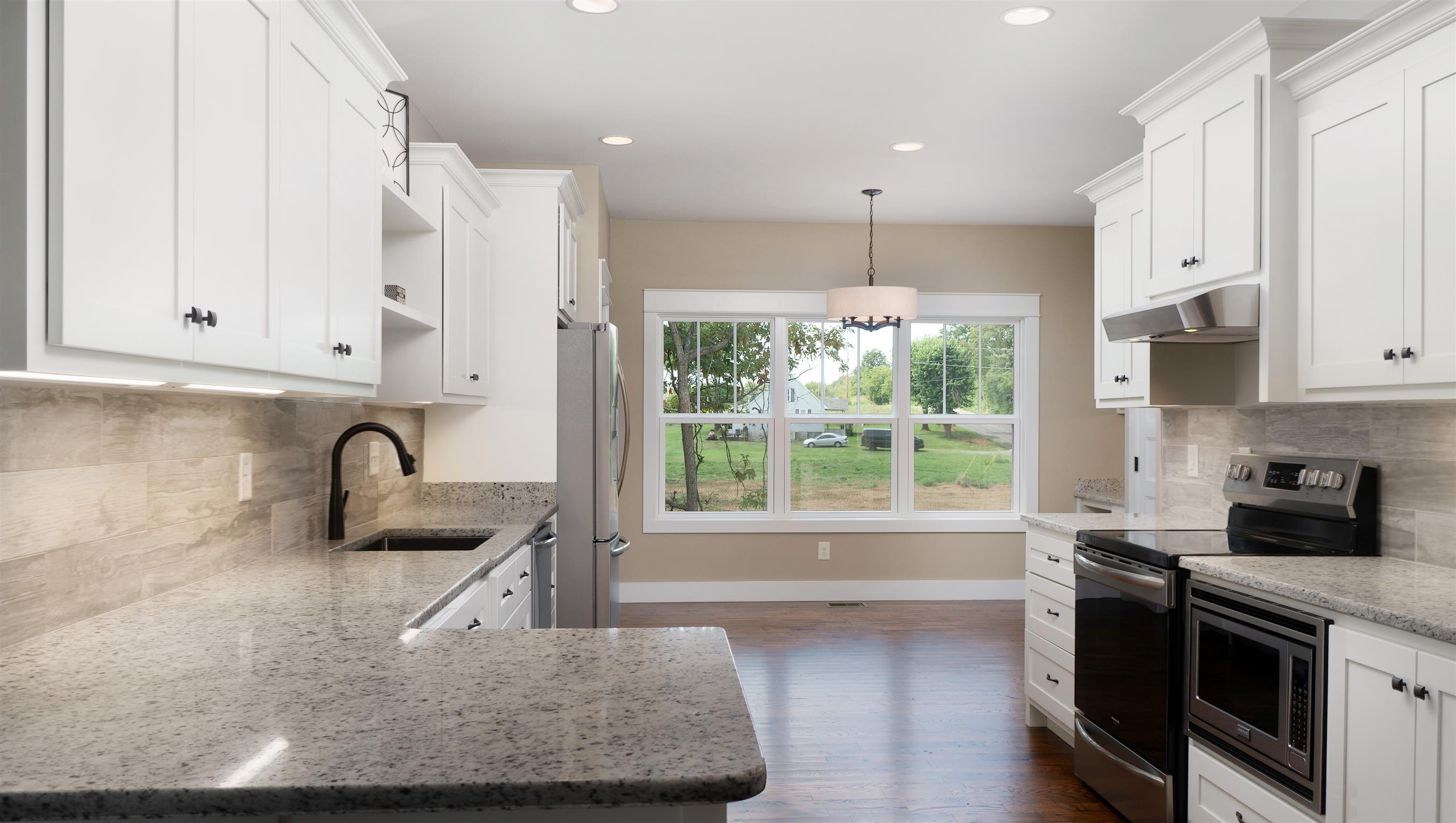 485 Tom Link Road Cottontown, TN 37048 - Photo 5 of 30 a kitchen with kitchen island granite countertop a stove and a sink with granite countertops