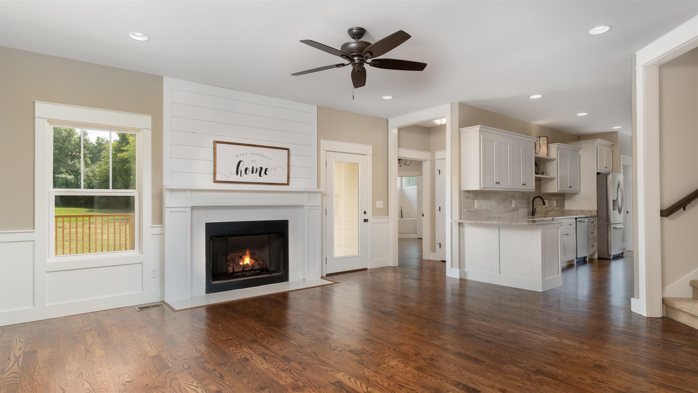 485 Tom Link Road Cottontown, TN 37048 - Photo 30 of 30 a view of an empty room with a kitchen and a fireplace