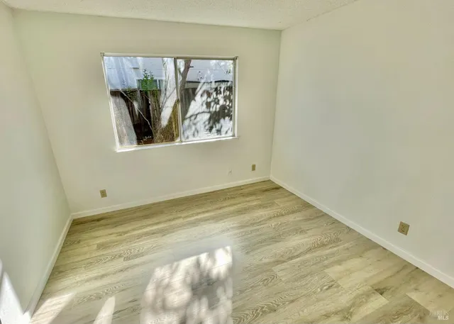 a view of staircase with wooden floor and white walls
