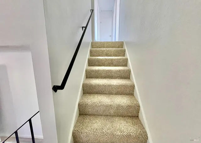 a bathroom with a sink mirror vanity and toilet