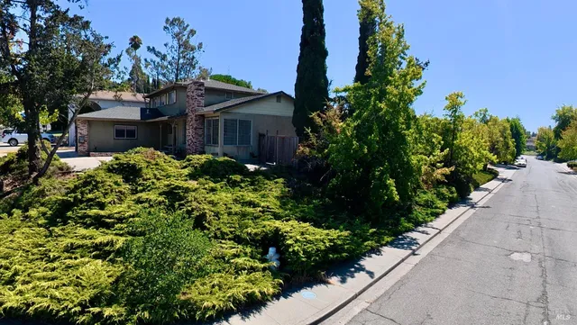 a view of a house with a flower garden