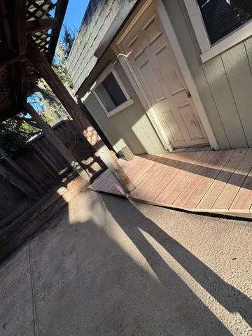 a backyard of a house with table and chairs