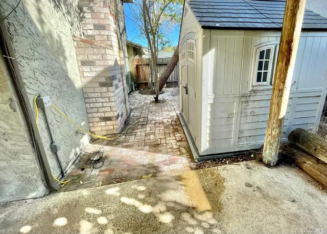 a view of a house with pool yard and sitting area