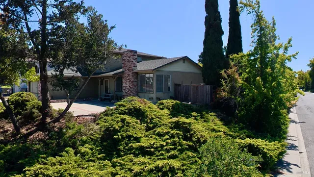a view of a house with a flower garden