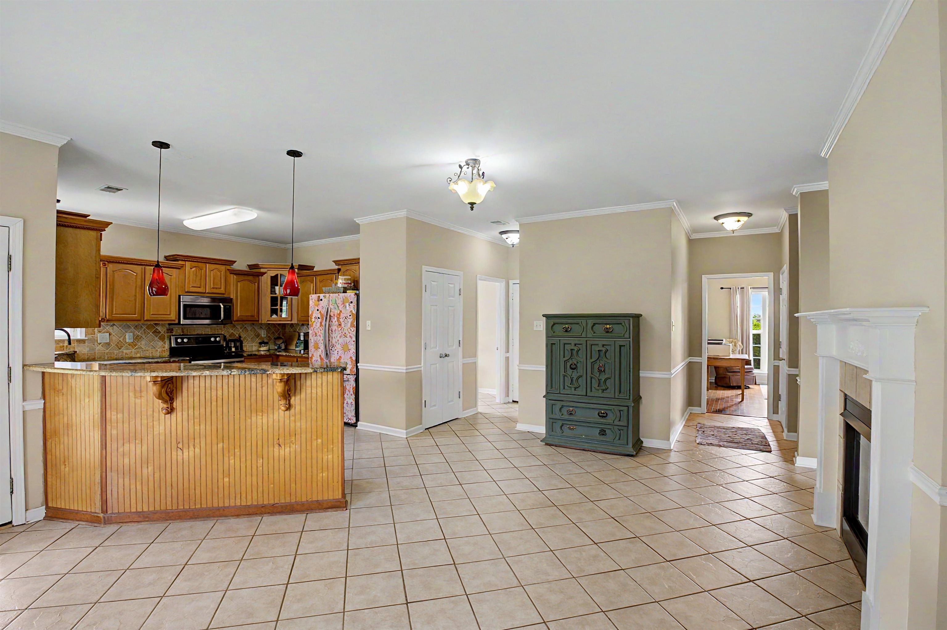 134 Rembert Drive Atoka, TN 38004 - Photo 17 of 38 Kitchen with wood cabinetry, integrated microwave, and a tiled backsplash