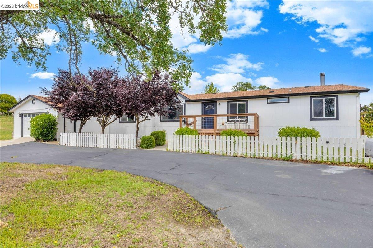 4419 Little John Road Copperopolis, CA 95228 - Photo 43 of 43 White exterior with a front deck, surrounded by a white picket fence