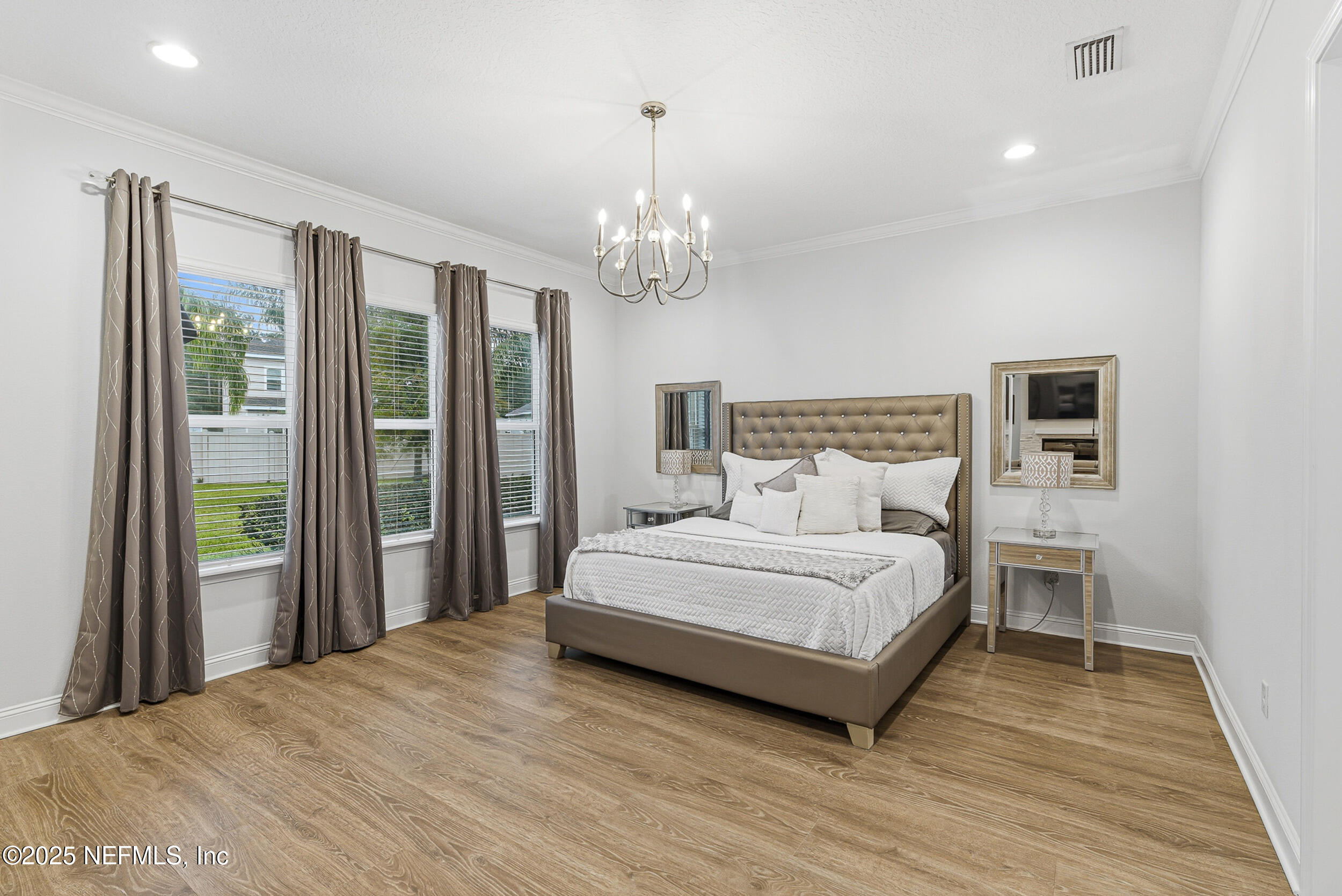 375 Kirkside Avenue St. Augustine, FL 32095 - Photo 17 of 49 a spacious bedroom with a large bed and a chandelier