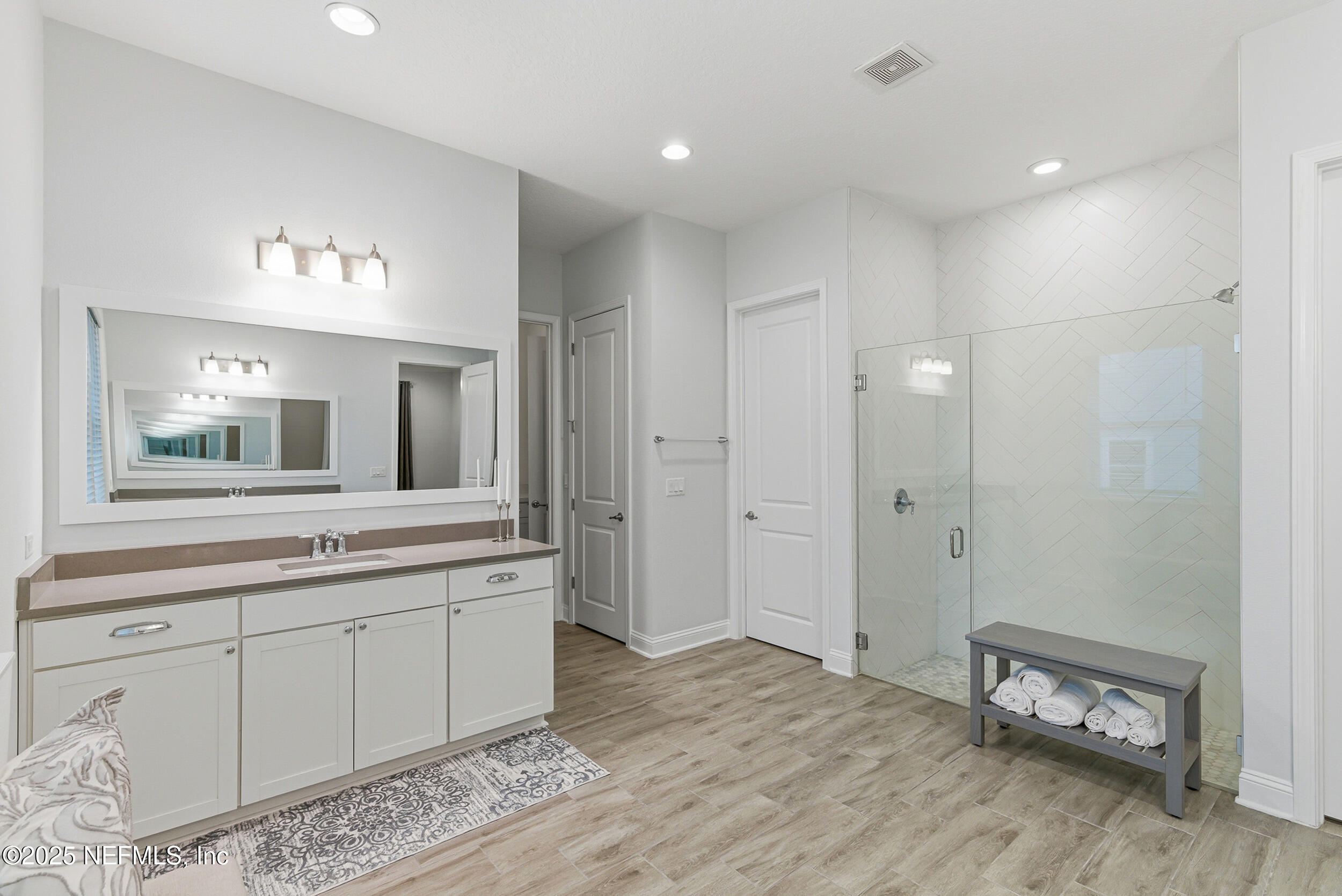 375 Kirkside Avenue St. Augustine, FL 32095 - Photo 19 of 49 a spacious bathroom with a granite countertop sink and a mirror