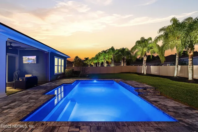 a view of swimming pool with outdoor seating