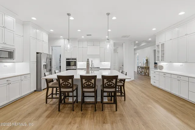 a large kitchen with a table and chairs