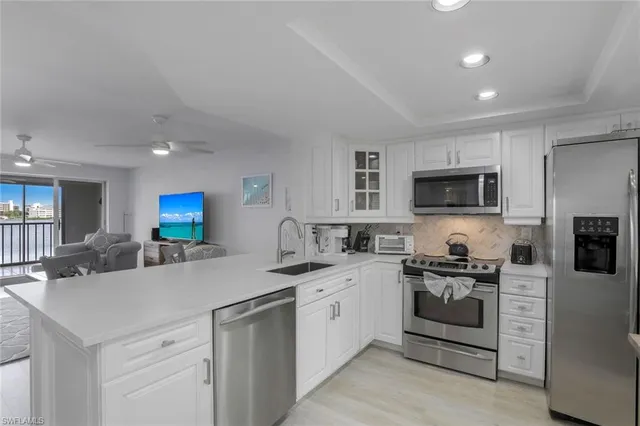 a kitchen with stainless steel appliances a sink stove and cabinets