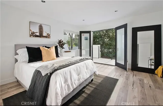 a bedroom with a large bed and a large window