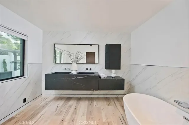 a bedroom with a large bed and a large window