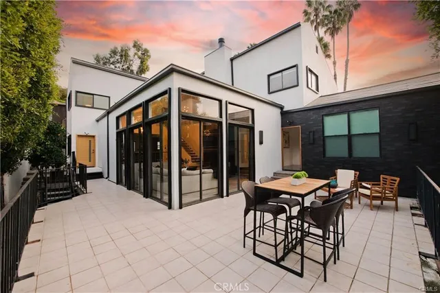 a view of a patio with table and chairs and potted plants