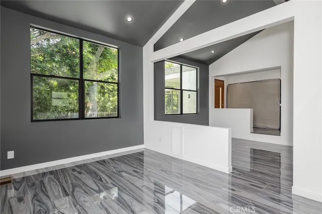 a kitchen with stainless steel appliances kitchen island granite countertop a refrigerator and a sink