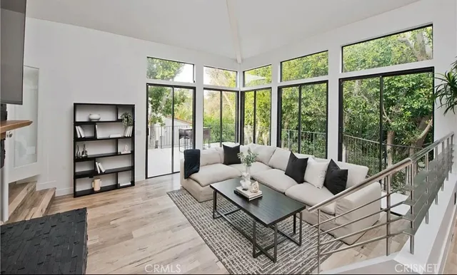 a living room with furniture and a floor to ceiling window