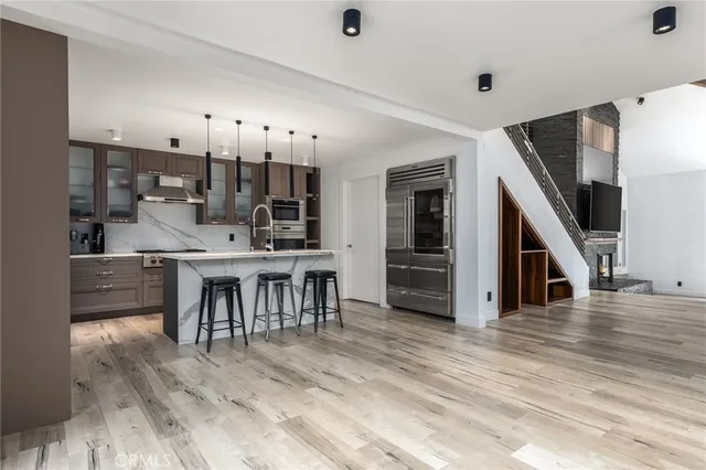 a view of a kitchen with dining room and wooden floor
