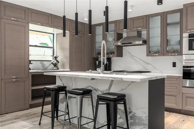 a kitchen with a sink and chairs