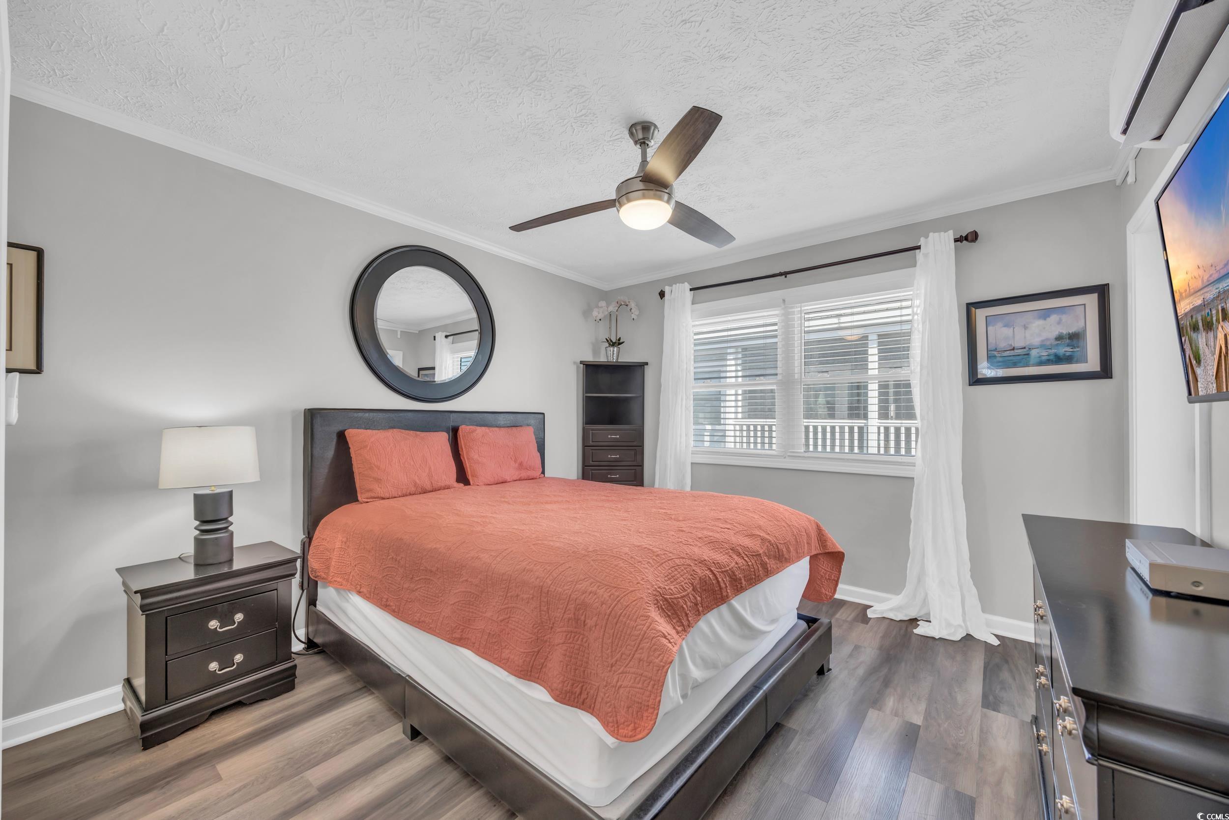 2405 South Ocean Boulevard, Unit 306 North Myrtle Beach, SC 29582 - Photo 15 of 37 Bedroom featuring a textured ceiling, dark hardwoo