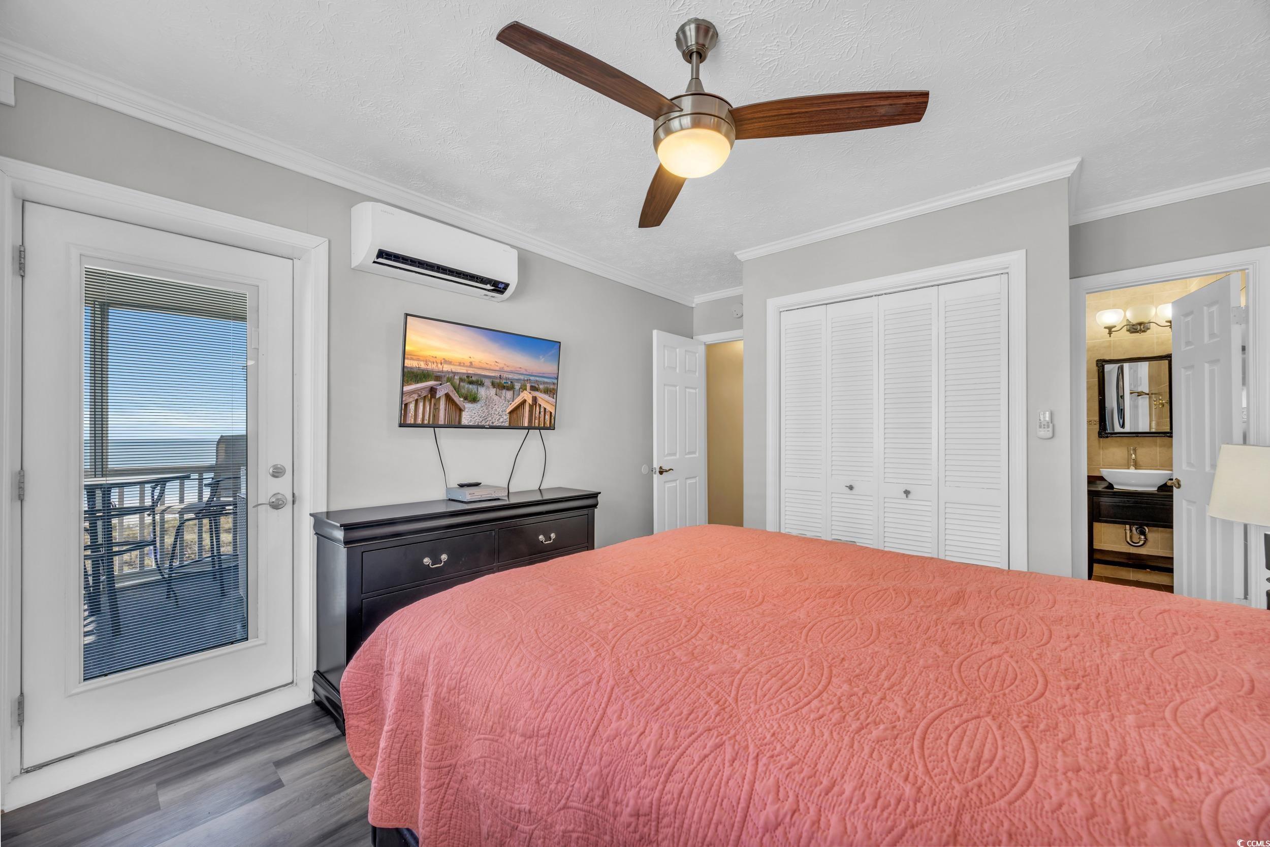 2405 South Ocean Boulevard, Unit 306 North Myrtle Beach, SC 29582 - Photo 16 of 37 Bedroom with ensuite bath, ceiling fan, a wall mou