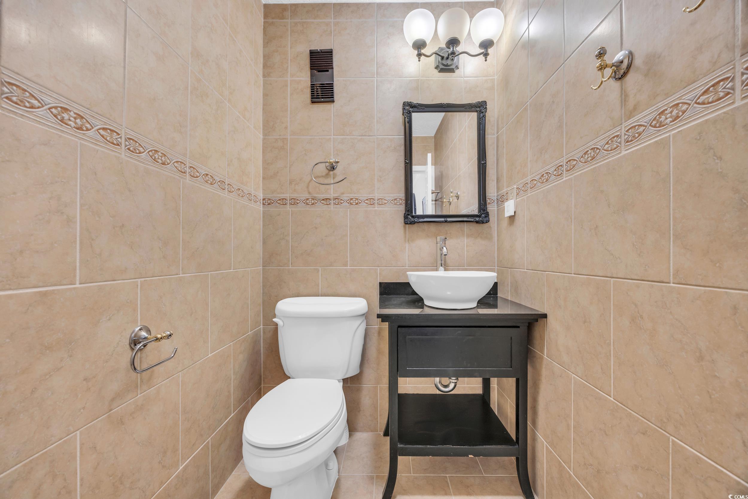 2405 South Ocean Boulevard, Unit 306 North Myrtle Beach, SC 29582 - Photo 17 of 37 Bathroom with tile patterned floors, vanity, toile