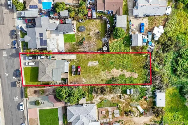 an aerial view of a house with garden space ocean view and mountain view in back