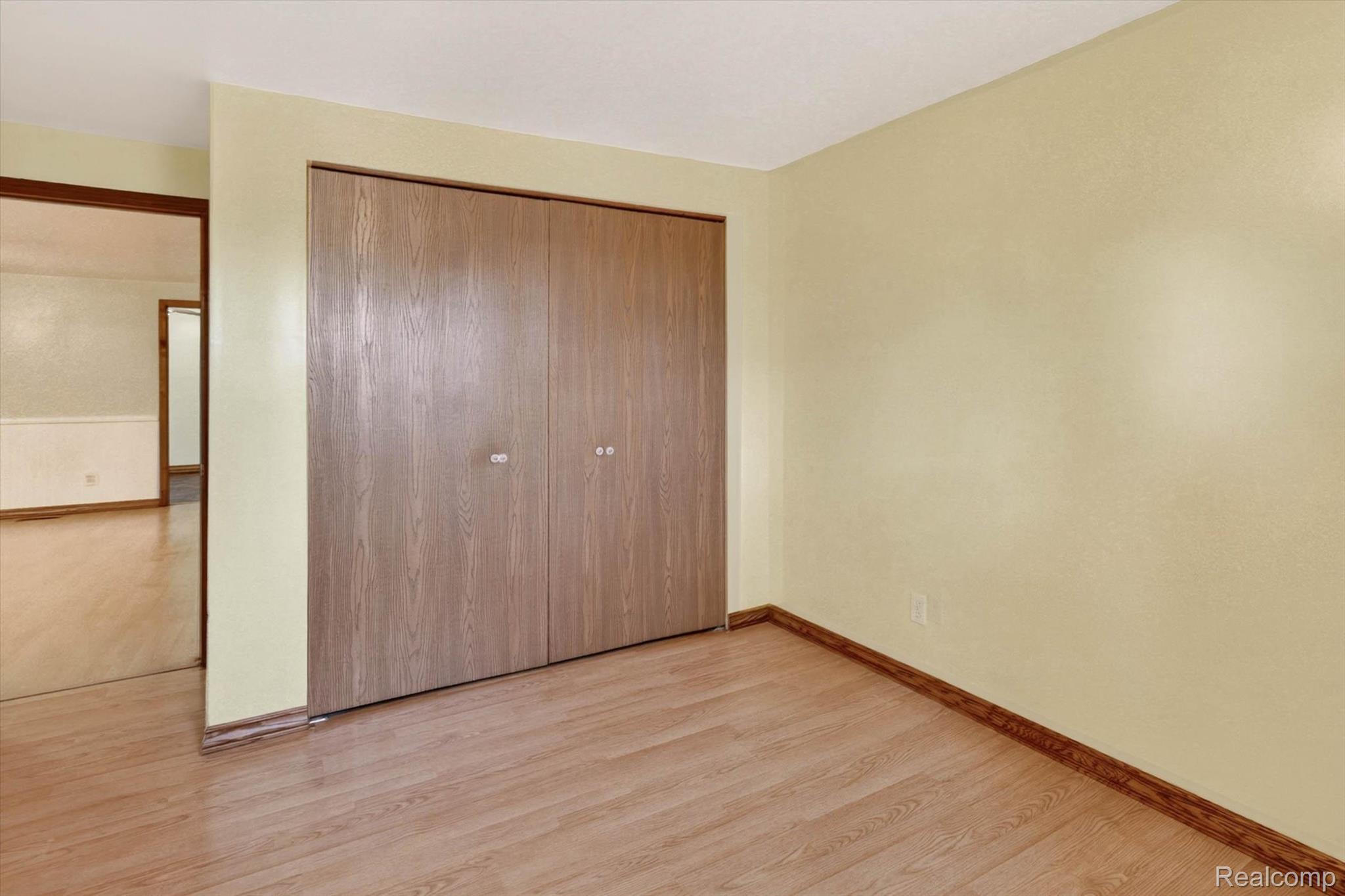 7974 West Gilford Road Reese, MI 48757 - Photo 16 of 36 Unfurnished bedroom featuring light wood-style flooring and a closet