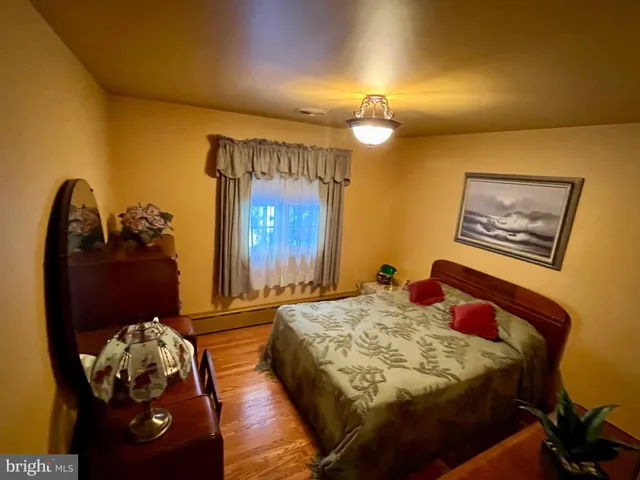 a bedroom with a bed and a mirror