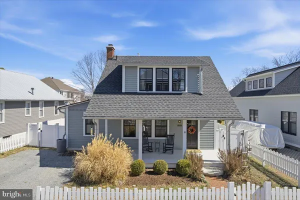 a view of a house with wooden fence