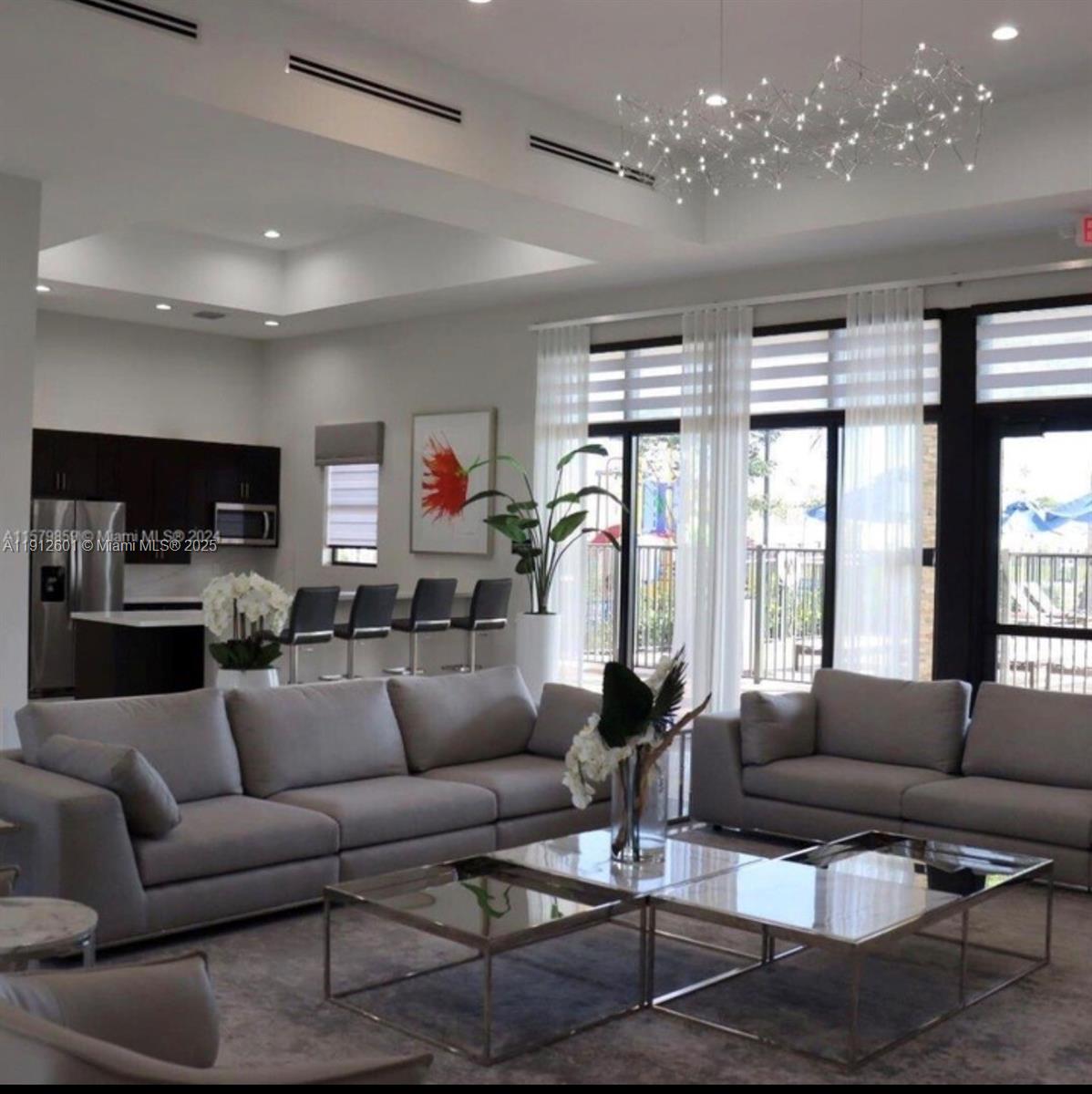 561 Northeast 208th Terrace, Unit 561 Miami, FL 33179 - Photo 15 of 31 a living room with furniture and a large window