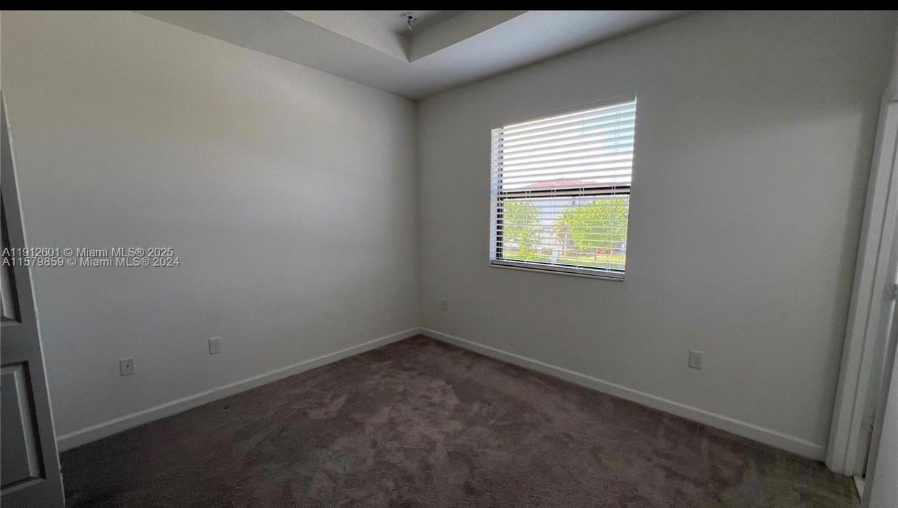 561 Northeast 208th Terrace, Unit 561 Miami, FL 33179 - Photo 22 of 31 an empty room with a window
