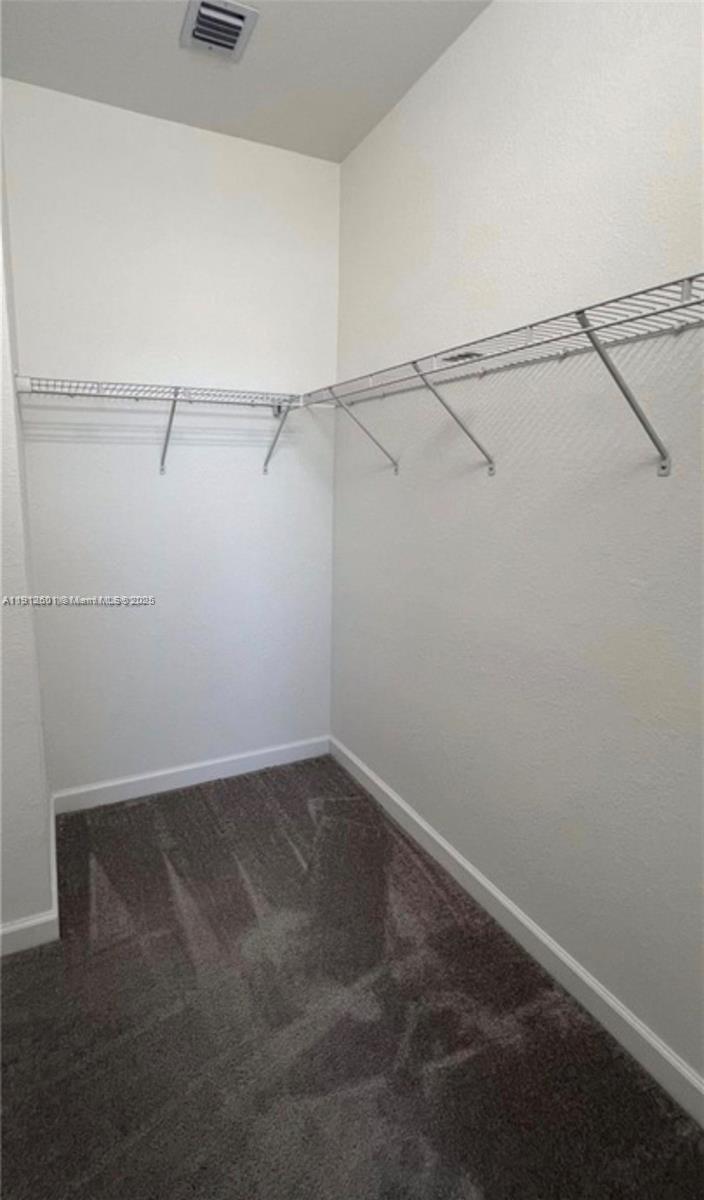 561 Northeast 208th Terrace, Unit 561 Miami, FL 33179 - Photo 26 of 31 a view of a room with racks on the wall