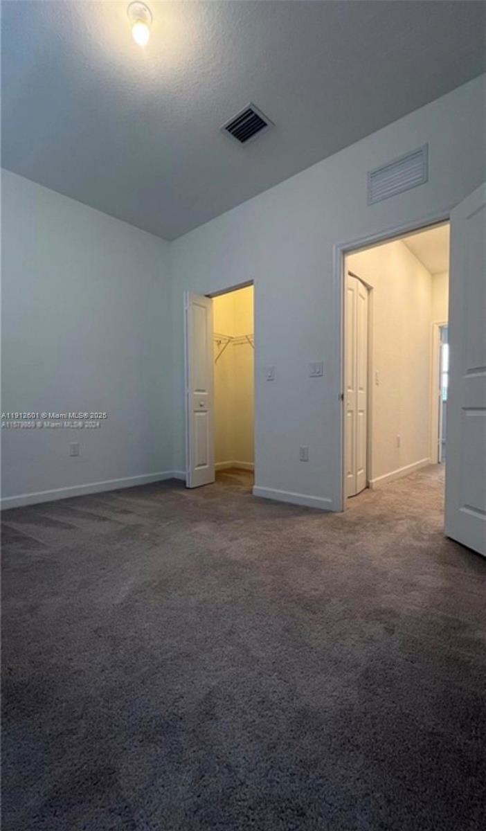 561 Northeast 208th Terrace, Unit 561 Miami, FL 33179 - Photo 27 of 31 an empty room that has windows